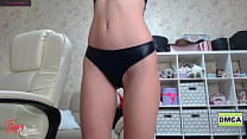 In a private setting, the well-known webcam model Mia dances.