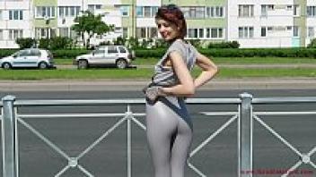 Natalia, decked out in a pair of tight leggings, strolls down the street.