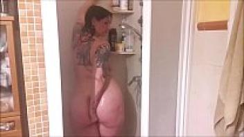 In the shower, your horny wife is masturbating for you.