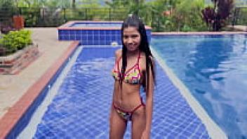 Adorable teenager Katherin Moore and her group were having a great time in the pool on a bright day.