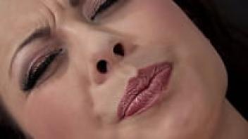 A brunette woman wearing black stockings masturbate.