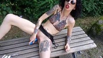 Lucy Ravenblood in a public park, smoking and diloing her pussy