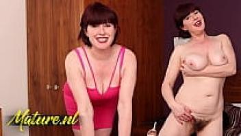 Janey, a gorgeous British cougar, is pulling a vibrator up her hairy pussy.