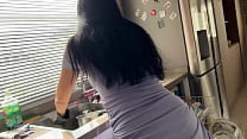 adored a gorgeous stepmother in the kitchen wearing a little dress.