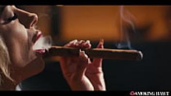 Smoking a 9-inch cigar and masturbating while giving a blowjob, this horny milf has enormous tits.