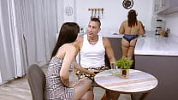 In the kitchen, I'm infatuated with my neighbor's husband without her seeing.