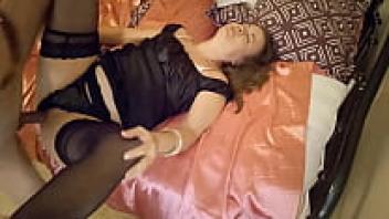 A French amateur babe wearing a black dress, black satin panties, a black satin garter belt, stockings, heels, a rimming technique, a doggystyle, and sex toys in 1984