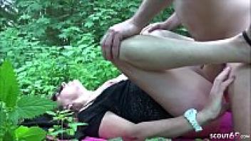 Hilde receives affection from a young boy at a family picnic outside.