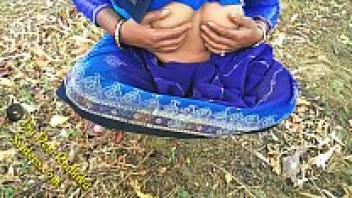 Desi Radhika, an Indian village woman with a naturally hairy pussy, engaging in outdoor sex
