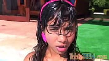 A teenage girl with little tits fingered the pool by herself.