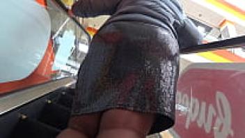Mature BBW is spied on by a voyeur at a public mall. A large ass beneath a tight skirt and fat legs in nylon Fetish for amateur feet