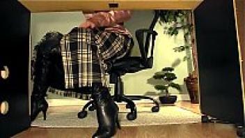 Video of a secretary masturbating while wearing boots beneath her desk